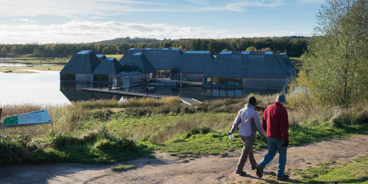 Two people walking past Brockholes in Preston Two people walking past Brockholes in Preston