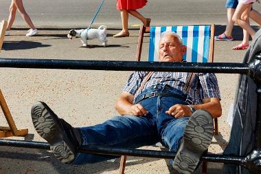 Martin Parr photography - man sleeping on deck chair