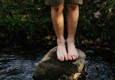 Child on stepping stone