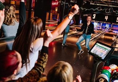 People enjoying a game of bowling