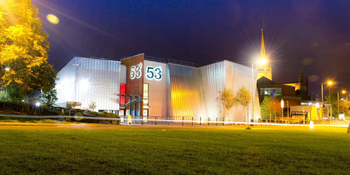 The 53 Degree building lit up with lights at night