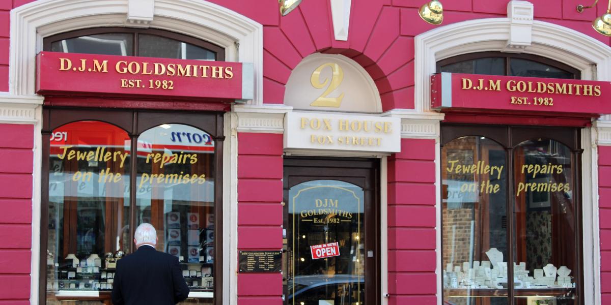 Man looking into the window of an independent jewellery shop.