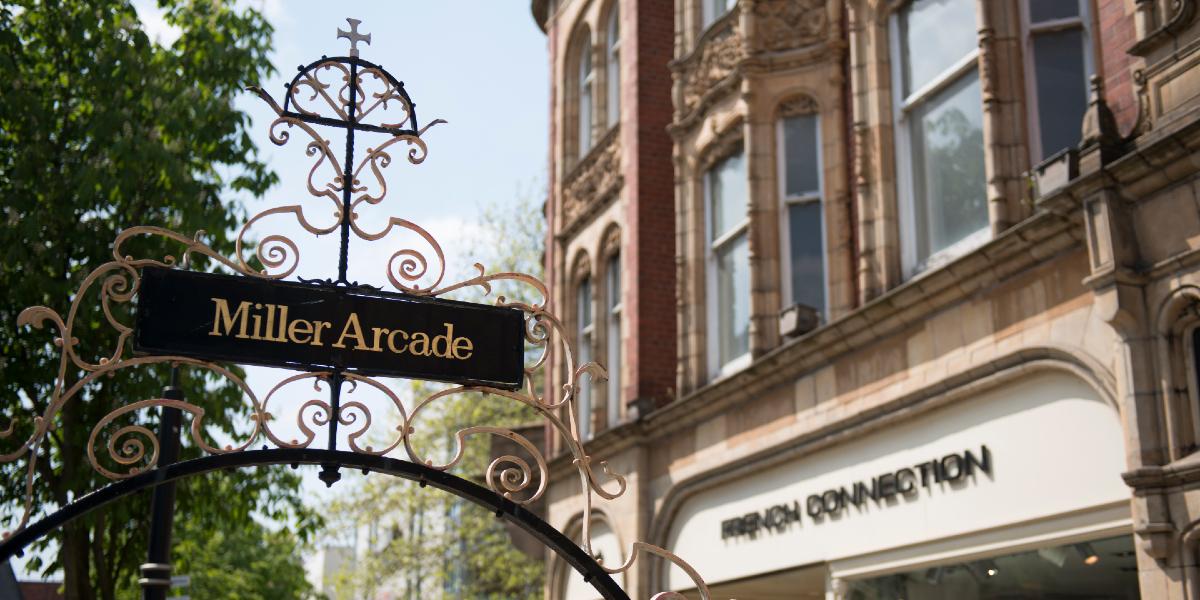 Miller Arcade signpost with French Connection store in the background.