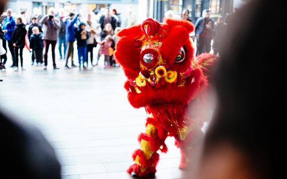 Lion dancer performing outside Preston Markets.