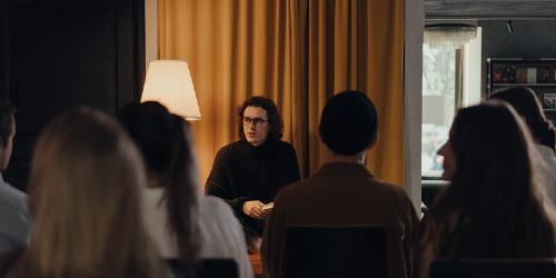 Man reading at a book club. Man reading at a book club.