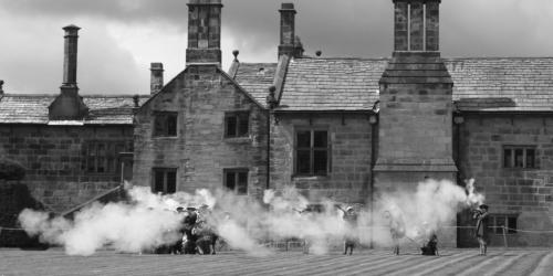 Black and white photograph of Battle of Preston reenactment at Hoghton Tower.