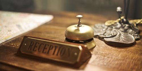 Page Icon: Reception sign and bell inside bed and breakfast. Reception sign and bell inside bed and breakfast accommodation.