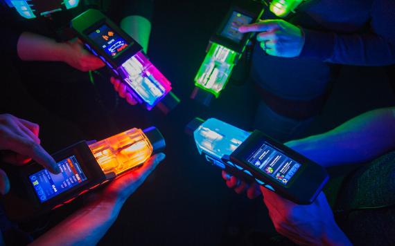 Laser Quest equipment on display, lit up in green.