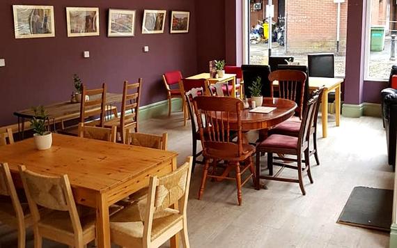 Seating and artwork inside The Larder cafe.