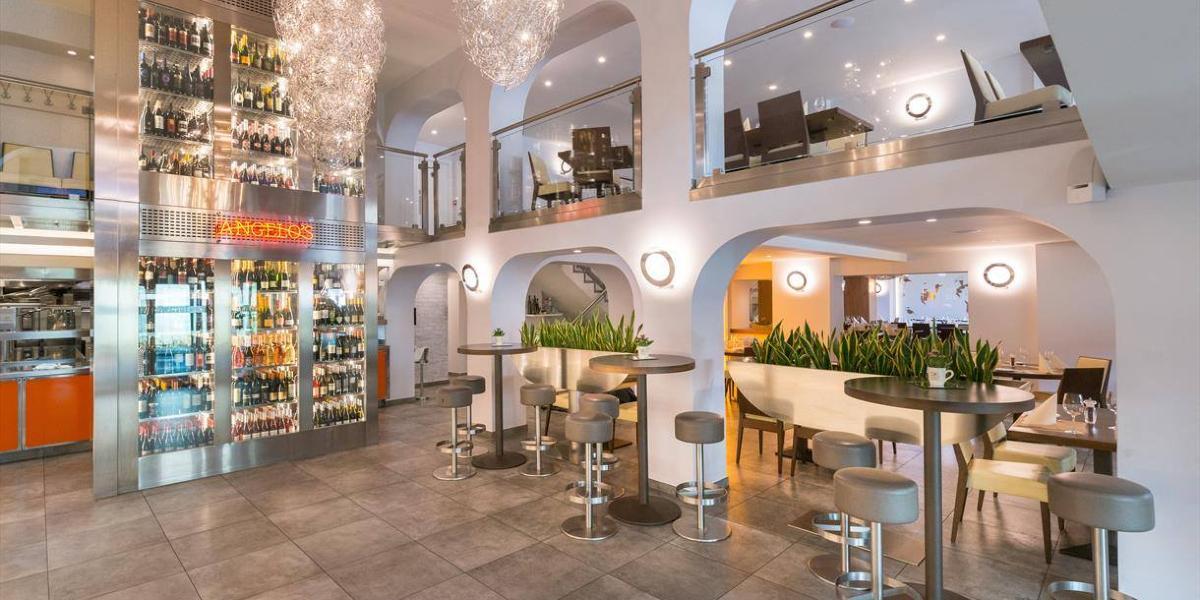 Main image: Seating and bar area inside Angelos Preston. Seating and bar area inside Angelos Preston.