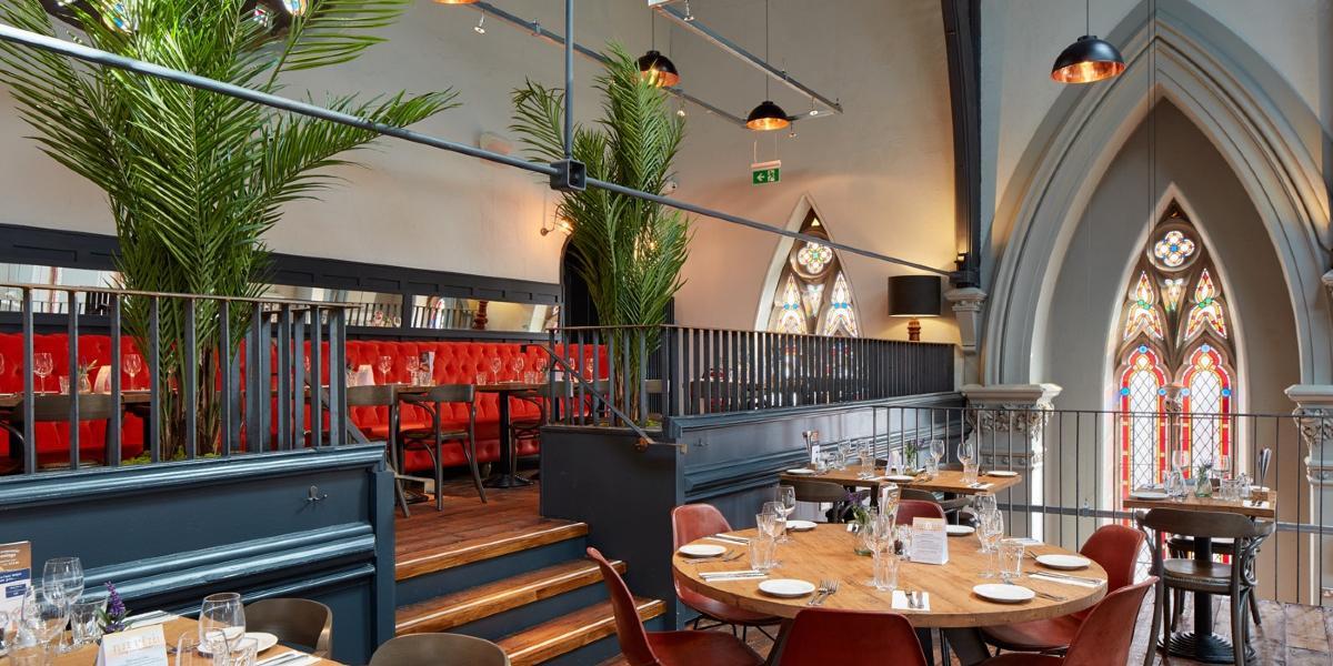 Main image: Red bench seating and dining tables in Preston's Bistrot Pierre upstairs dining area. Red bench seating and dining tables in Preston's Bistrot Pierre upstairs dining area.