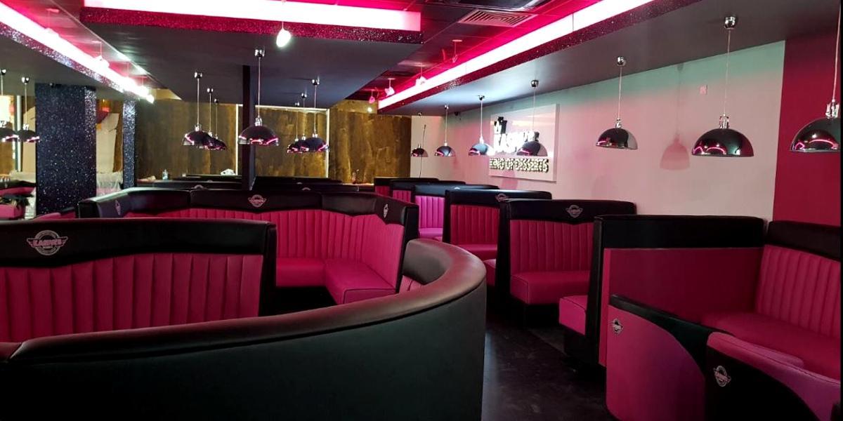 Main image: Pink and black booths inside Kaspa's Preston. Pink and black booths inside Kaspa's Preston.
