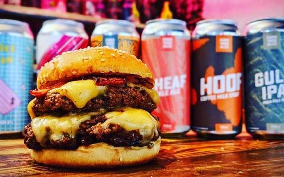 Burger and cans of craft beer.