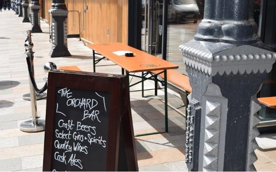Blackboard outside The Orchard in outdoor seating area.