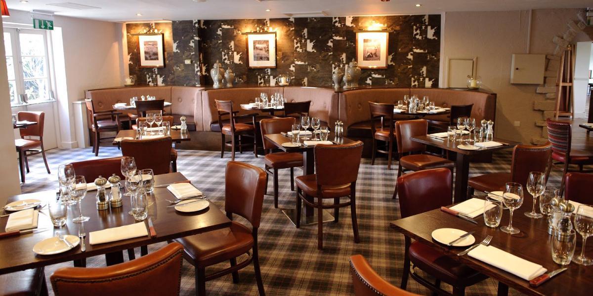 Macdonald Tickled Trout Hotel dining area. Macdonald Tickled Trout Hotel dining area with check floor and brown leather seating.