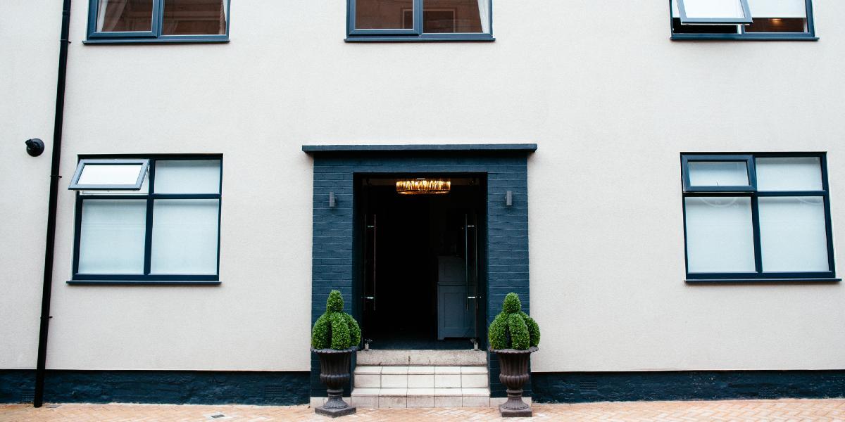 No.10 Preston black and white exterior entrance. Black and white exterior of No.10 Preston with potted plants.