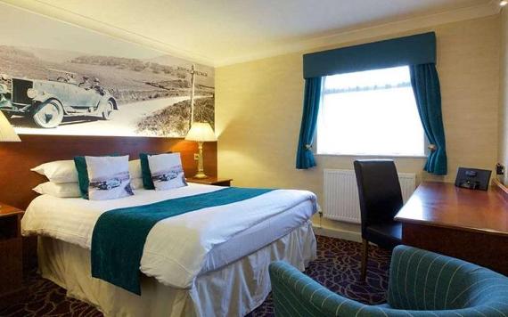 Blue themed hotel room with retro artwork on wall at Preston Leyland Hotel.