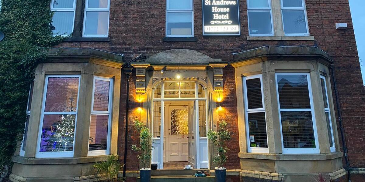 Main image: Front exterior of St Andrews House Hotel, Preston. Front exterior of St Andrews House Hotel, lit up at night.