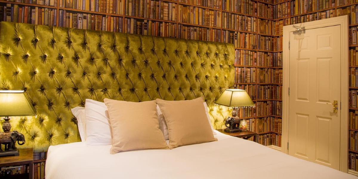 Main image: Winckley Square Hotel double bedroom with wallpaper in the style of books on shelves. Winckley Square Hotel double bedroom with wallpaper in the style of books on shelves.