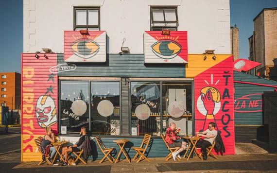 Front of La Neta restaurant, decorated with colourful imagery.