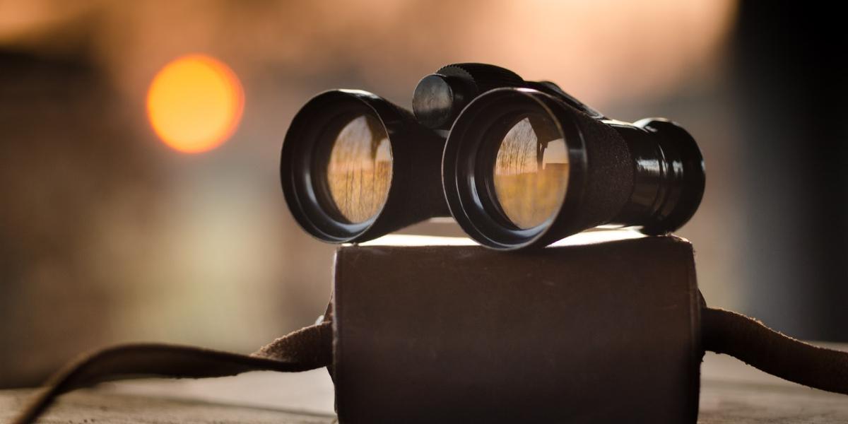 Main image Preston Society Birdwatching & Natural History Binoculars placed on case with reflection of trees in lenses.