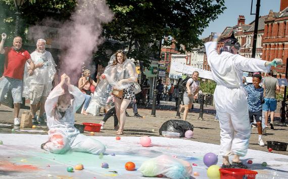 Women throwing paint bombs on Preston Flag Market during Lancs Encounter 2021. Photo by Michael Porter Photography.