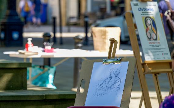 Still life drawing taking place on Preston Flag Market.