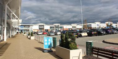 Deepdale Shopping Park stores and car parking area.